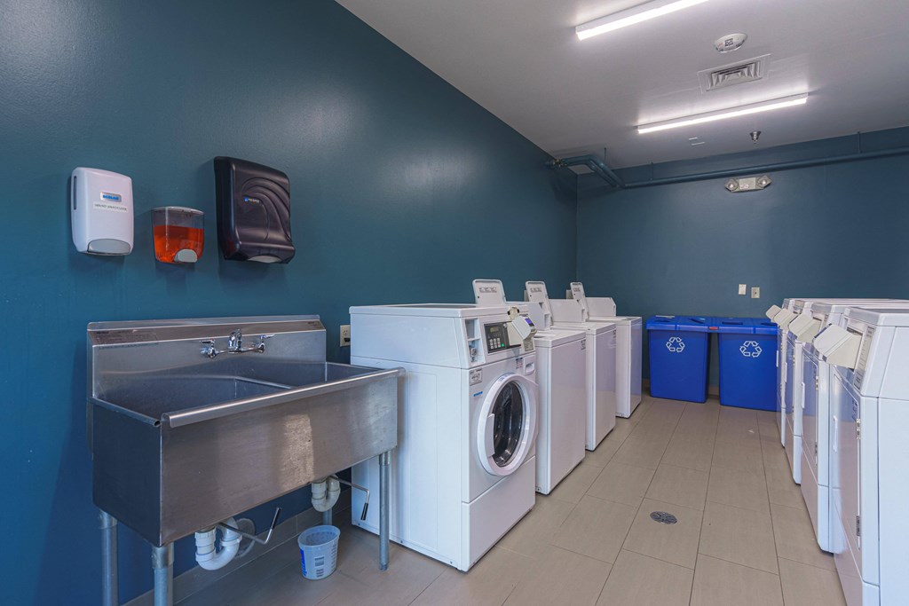 a laundry room with washes and washing machines and a sink